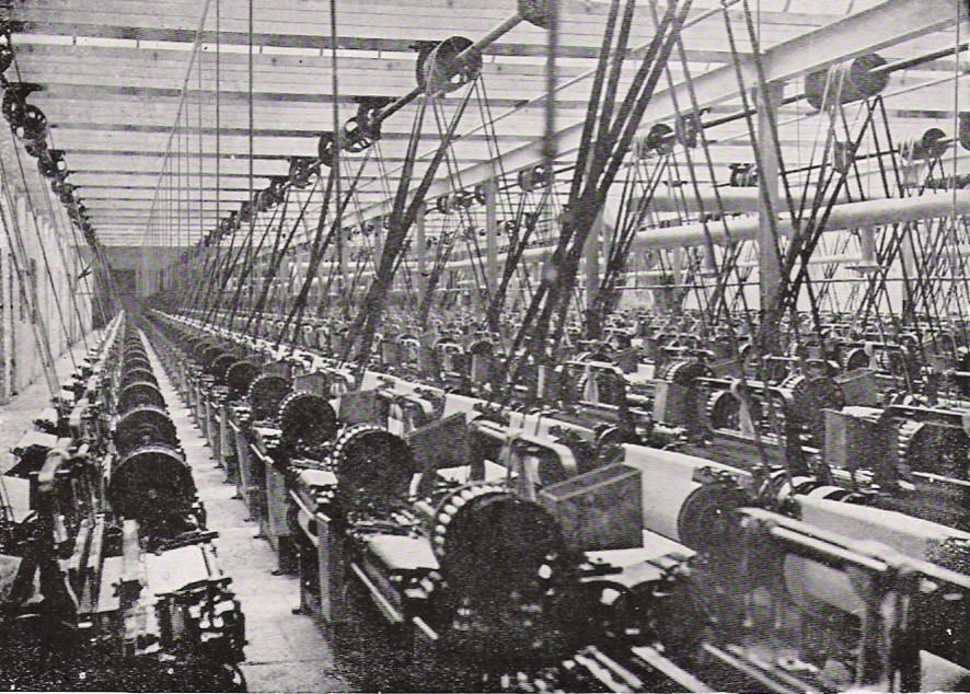 Factory using steam engines and long belts to run its looms